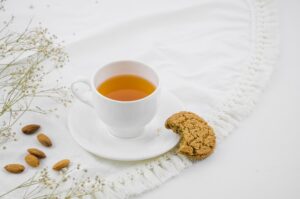 eaten cookies almonds with white herbal tea cup tablecloth 23 2148124141