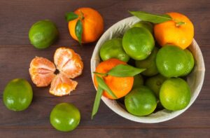 top view mandarins basket green lemons wood surface 176474 514